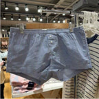Shorts à carreaux rouges avec taille élastique et décoration de fermeture pour femmes