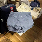 Shorts à carreaux rouges avec taille élastique et décoration de fermeture pour femmes