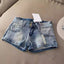 Short en jean rétro de couleur claire à la mode pour femme
